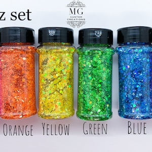 May include: A set of six 2 oz jars of iridescent glitter in pink, orange, yellow, green, blue, and purple. The jars are labeled with the color of the glitter.