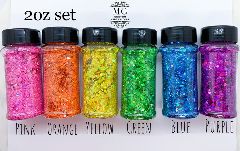 May include: A set of six 2 oz jars of iridescent glitter in pink, orange, yellow, green, blue, and purple. The jars are labeled with the color of the glitter.