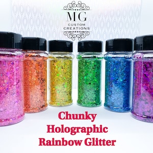 May include: Six jars of chunky holographic rainbow glitter. The jars are clear and have black lids. The glitter is in a variety of colors, including pink, orange, yellow, green, blue, and purple.