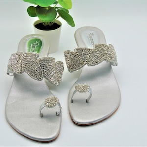 sliver toe ring wedge heels with embroidered sliver beads on a petal design strap