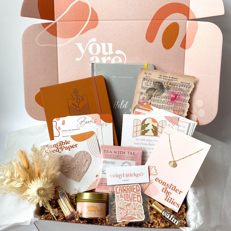 care package gift for a miscarriage grief with books, journals, necklace, wildflower seeds, tea and candles