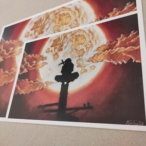 May include: A black silhouette of a person standing on a platform in front of a large, red moon with gold clouds. The moon is surrounded by a dark red sky.