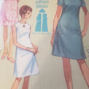May include: A vintage Simplicity sewing pattern for a dress. The pattern is for a Jiffy dress with three main pattern pieces. The pattern is easy-cut and easy-sew. The pattern number is 7072 and the year is 1969.