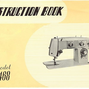 May include: An instruction book and a sewing machine are featured in this image. The book's title, "INSTRUCTION BOOK," is printed in bold black letters. The sewing machine is light gray with several dials and settings. The model number "2468" is also visible.