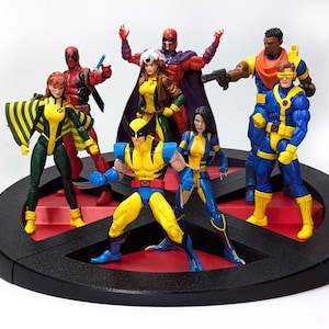 May include: A set of 8 action figures of X-Men characters, including Wolverine, Cyclops, Rogue, Storm, Magneto, Deadpool, and Jean Grey. The figures are posed in dynamic action stances and are displayed on a black and red X-Men logo base.