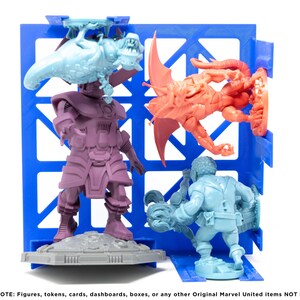 May include: Four miniature figures, painted in different colors, are displayed on a blue plastic grid. The figures are a purple and gray humanoid, a blue humanoid, a red and orange dragon-like creature, and a light blue creature with a long tail.