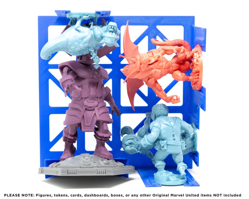 May include: Four miniature figures, painted in different colors, are displayed on a blue plastic grid. The figures are a purple and gray humanoid, a blue humanoid, a red and orange dragon-like creature, and a light blue creature with a long tail.