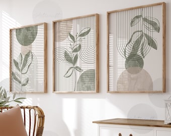 May include: Three framed botanical art prints with abstract designs in shades of green and beige. The prints feature leaf and line art. The room also includes a wicker chair with a pillow and blanket, a white cabinet, and a woven basket.