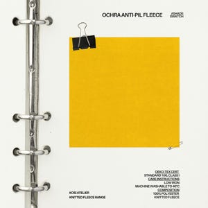 May include: A sample of ochra anti-pil fleece fabric, attached to a binder. The fabric is a solid mustard yellow color. The text "OCHRA ANTI-PIL FLEECE" and "#SHADE SWATCH" are printed at the top. Additional text includes care instructions and fabric composition.