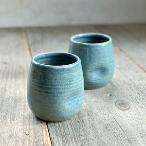 Hand made tumbler with dimple in blue, hand made in stoneware pottery, thumb cup beaker