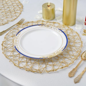 May include: Gold wire charger with a white plate with a blue and gold rim. The plate is on top of the charger.