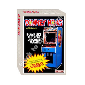 Può includere: Una scatola per il videogioco Donkey Kong di Nintendo per ColecoVision. La scatola presenta un'esplosione gialla con le parole "High Resolution Video Cartridge for ColecoVision" in rosso. La scatola presenta anche un'immagine del gioco arcade Donkey Kong.
