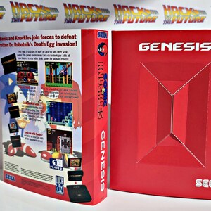 K&ouml;nnte beinhalten: Rote SEGA Genesis-Spielbox f&uuml;r "Sonic and Knuckles". Die Box zeigt Spiel-Screenshots, das SEGA-Logo und den Text "Sonic and Knuckles join forces to defeat Dr. Robotnik's Death Egg invasion!"
