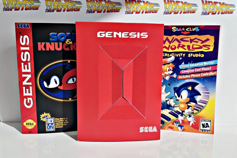 K&ouml;nnte beinhalten: Drei SEGA Genesis Videospielboxen. Die Boxen sind rot, schwarz und blau. Die Boxen haben das SEGA-Logo und Spieletitel wie "Sonic & Knuckles" und "Wacky Worlds Creativity Studio". Die rote Box hat das Wort "GENESIS" in Wei&szlig;.