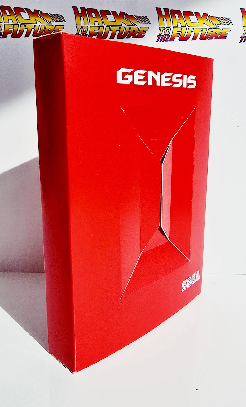 K&ouml;nnte beinhalten: Eine leuchtend rote Box mit dem Wort "GENESIS" in wei&szlig;er Schrift. Die Box hat ein geometrisches Design auf der Vorderseite und das SEGA-Logo ist sichtbar. Der Hintergrund zeigt die Worte "HACK TO FUTURE" in einem sich wiederholenden Muster.
