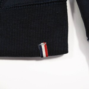 May include: A navy blue sweatshirt with a ribbed hem and a red, white, and blue striped label.