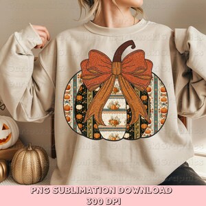 May include: A beige sweatshirt with a pumpkin design. The pumpkin has a brown stem and a large orange bow. The pumpkin design includes patterns of pumpkins and floral elements. The text "PNG SUBLIMATION DOWNLOAD" and "300 DPI" is at the bottom.