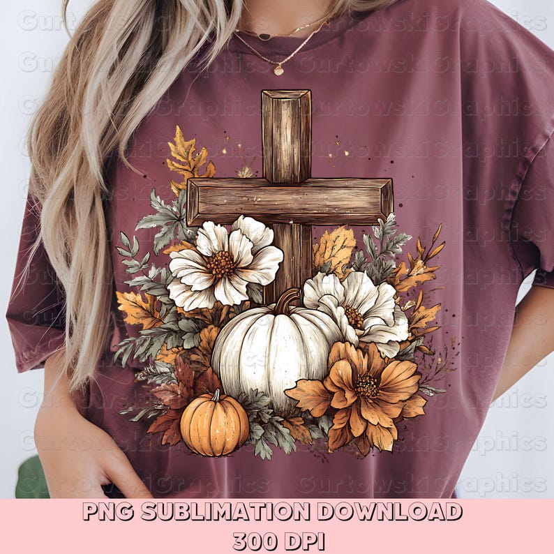 May include: Burgundy t-shirt featuring a wooden cross design with a white pumpkin, orange and white flowers, and fall foliage. The design includes a small orange pumpkin and the text "PNG SUBLIMATION DOWNLOAD 300 DPI".