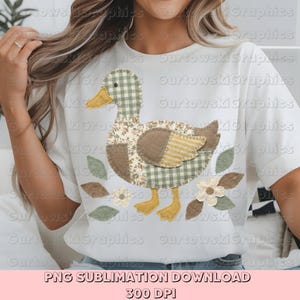 May include: White t-shirt featuring a patchwork duck design with floral, gingham, and striped patterns in shades of green, brown, and yellow. The duck is surrounded by leaves and flowers. The text "PNG SUBLIMATION DOWNLOAD 300 DPI" is at the bottom.