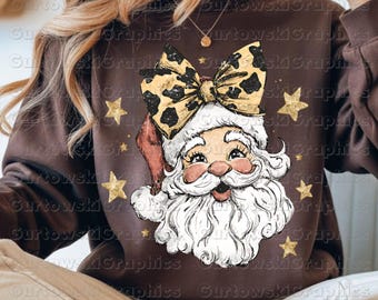 May include: A brown sweatshirt featuring a Santa Claus graphic with a leopard print bow and a red hat. Gold stars are scattered around the Santa design. The text "PNG SUBLIMATION DOWNLOAD" and "300 DPI" are at the bottom.