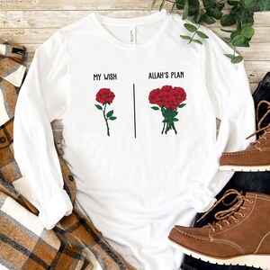May include: White long-sleeve t-shirt with the text "My Wish" and a single red rose on the left side and the text "Allah's Plan" and a bouquet of red roses on the right side.