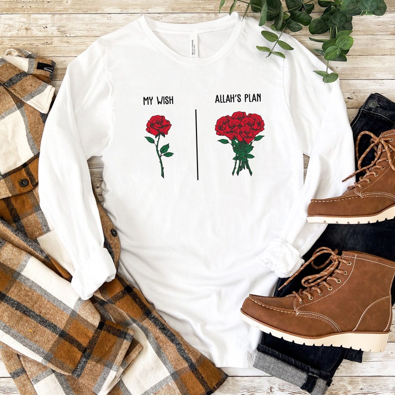 May include: White long-sleeve t-shirt with the text "My Wish" and a single red rose on the left side and the text "Allah's Plan" and a bouquet of red roses on the right side.