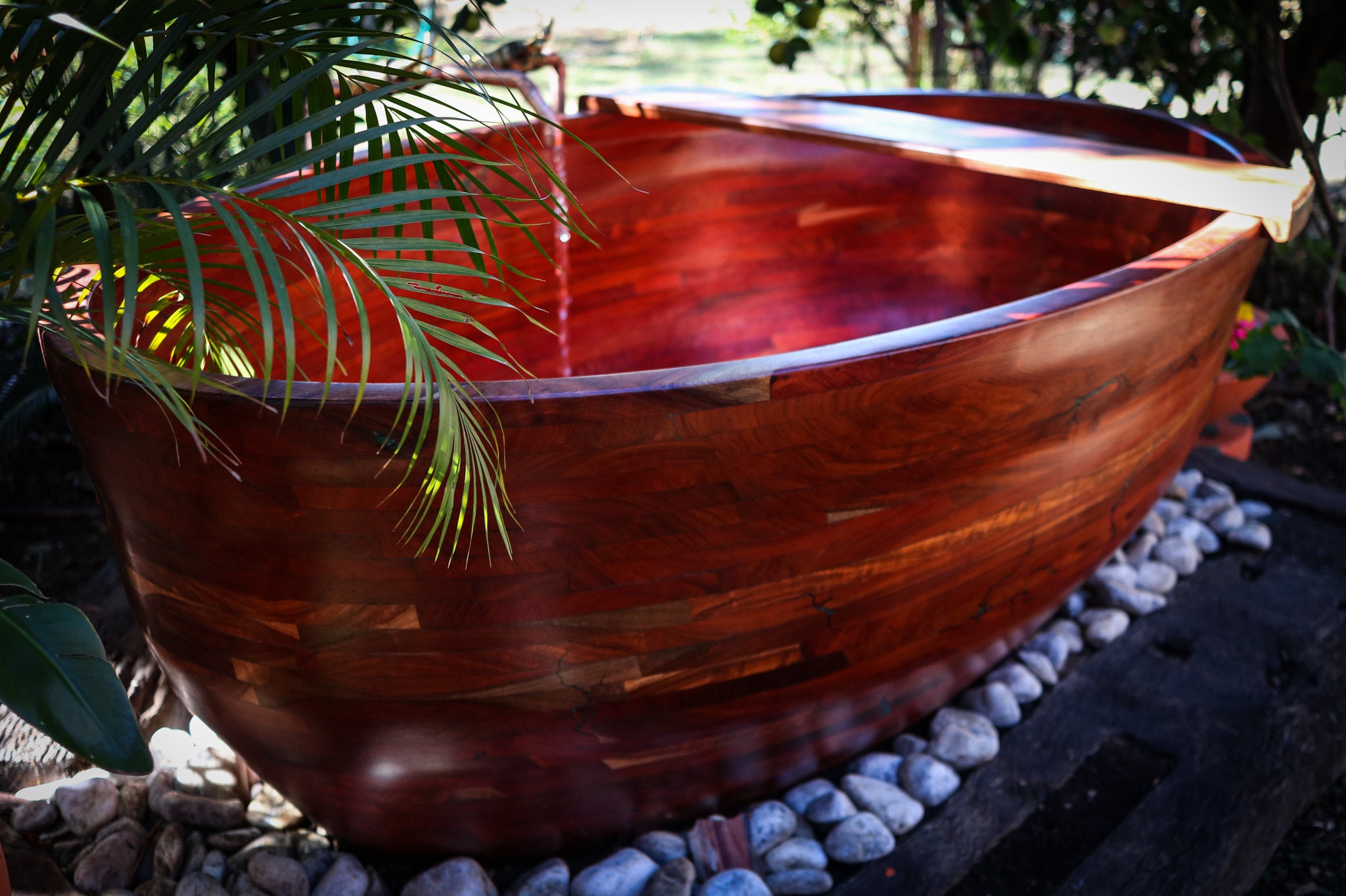 Wooden bathtub. Rosewood. Outdoors. Bath caddy included