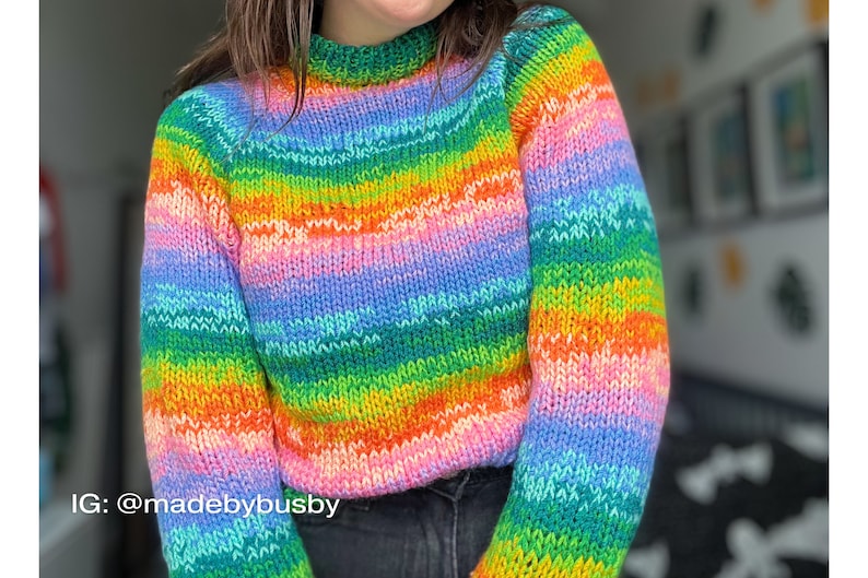 May include: A rainbow striped knitted sweater with a crew neck. The sweater is made with a soft, colorful yarn. IG: @madebybusby