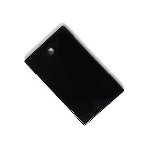 May include: A black rectangular pendant with a small hole at the top.