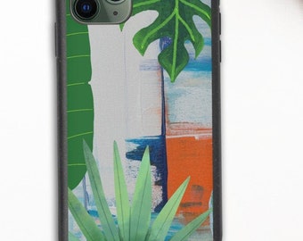 May include: A black phone case with a tropical leaf design. The case features a white background with green leaves and blue and orange abstract brushstrokes.