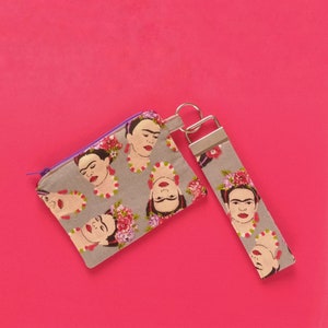 Frida Kahlo monedero con cremallera. Llavero de correa para muñeca Frida Kahlo. Portamonedas de tela estampado de Frida Kahlo en fondo gris.
