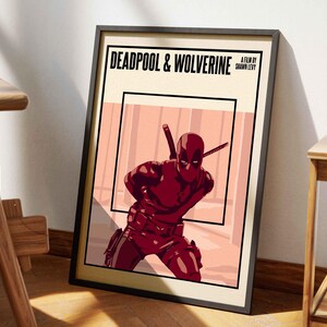May include: Framed poster featuring Deadpool & Wolverine. The artwork showcases Deadpool in a dynamic pose, clad in his signature red suit, with two katanas. The poster has a black frame and the title is displayed in bold, black text.
