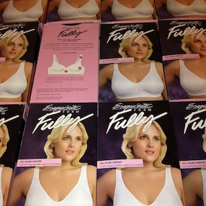 May include: Multiple boxes of white, full-figure wirefree bras. Each box features a woman wearing the bra, with the brand name "Exquisite Form Fully" displayed prominently. The boxes are arranged in rows.