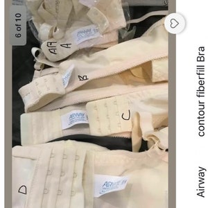 May include: A collection of beige contour fiberfill bras with pockets for pads. Various bra parts are shown, such as straps, hooks, and labels. The text "Airway" is visible on some labels. Sizes 32, 34, 36, 38, 40, and 42 are listed.