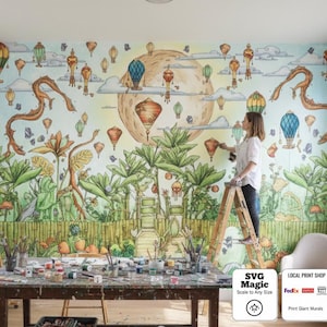 Może przedstawiać: Kolorowy mural przedstawiający balony na ogrzane powietrze, smoki i fantastyczne rośliny. Osoba maluje mural na drabinie. Scena obejmuje stół z materiałami artystycznymi i tekst "SVG Magic Scale to Any Size".