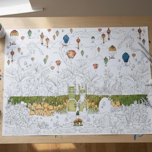 May include: A large, detailed coloring page featuring a whimsical landscape with hot air balloons in various colors. The scene includes a forest, buildings, and other elements, with art supplies like pencils and pastels on a wooden table.