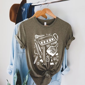 Camiseta de professor de arte: camiseta gráfica com materiais de arte