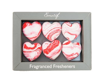 May include: Six heart-shaped, red and white marbled air fresheners in a gray box with the text "Emotif Fragranced Fresheners".