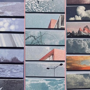 May include: A collection of rectangular stickers featuring various landscape and architectural scenes. The images include mountains, clouds, water, and buildings, with a color palette of blues, grays, and pinks. The stickers are arranged in vertical rows.