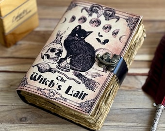 May include: A vintage-style leather-bound journal with a black cat, skull, and other witchy imagery on the cover. The cover reads "The Witch's Lair".