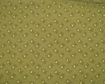 May include: An olive green fabric featuring a repeating pattern of small, light yellow crescent moons paired with dark brown sunburst icons arranged in diagonal rows across the entire surface of the textile material.
