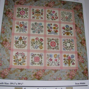 May include: A quilt pattern titled Flowers From My Garden by Lori Smith, featuring a 4x4 grid of floral applique blocks separated by pink sashing, surrounded by a floral border. The finished quilt size is listed as 59.25 inches by 59.25 inches.