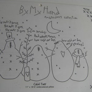 May include: A black and white line drawing pattern for an 11 inch by 18.5 inch embroidered pillow titled By My Hand. It features four snowmen, a crescent moon, stars, and the text: The more it snows, the more it goes, on snowing. And nobody knows, how cold our toes are growing!