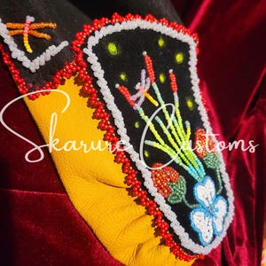 May include: Close-up of a beaded moccasin vamp with a floral design. The vamp is black with red, green, and white beads. The design features a cluster of flowers with green leaves and a dragonfly. The text "Vamps ONLY* Moccasins NOT included" is visible at the bottom of the image.