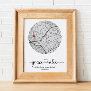 May include: A framed print with a map of a city in a circle. A red heart is placed on the map. The text below the map reads "grace &hearts; alex", "22 Hawthorne Mews, Sheffield", and "14.08.2023".