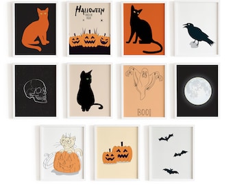 May include: A collection of eleven framed wall art prints featuring Halloween themes including orange and black cats, carved pumpkins, a skull, a raven, a ghost with the text BOO, a full moon, and bats on various colored backgrounds.