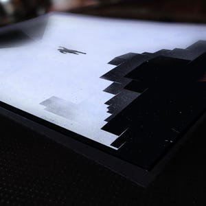 May include: A black and white abstract painting on a canvas with a black frame. The painting depicts a figure falling from the sky towards a city skyline.