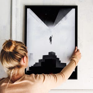 May include: Black and white minimalist art print featuring a silhouette of a person reaching up towards a geometric structure. The print has a distressed, textured look.