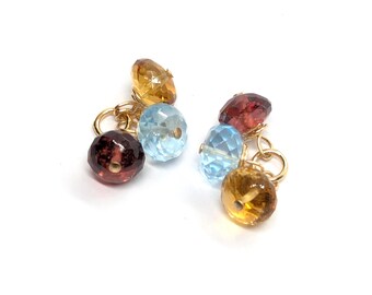 Pendientes con colgantes de topacio azul cielo, granate y citrino en oro laminado de 14 quilates.