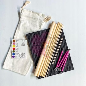 May include: A set of wooden dowels, a black mat, and a white bag with a label that reads "Julie's Sweet Flowers". The label also includes a color chart with different sizes: 3/4", 1/2", 5/16", 1/4", 3/16", and 1/8".